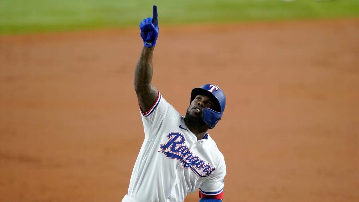 Texas Rangers’ Adolis Garcia celebrates his second inning home run Monday night at Globe Life Field. Garcia later became the fourth Rangers player to homer and steal home in the same game.