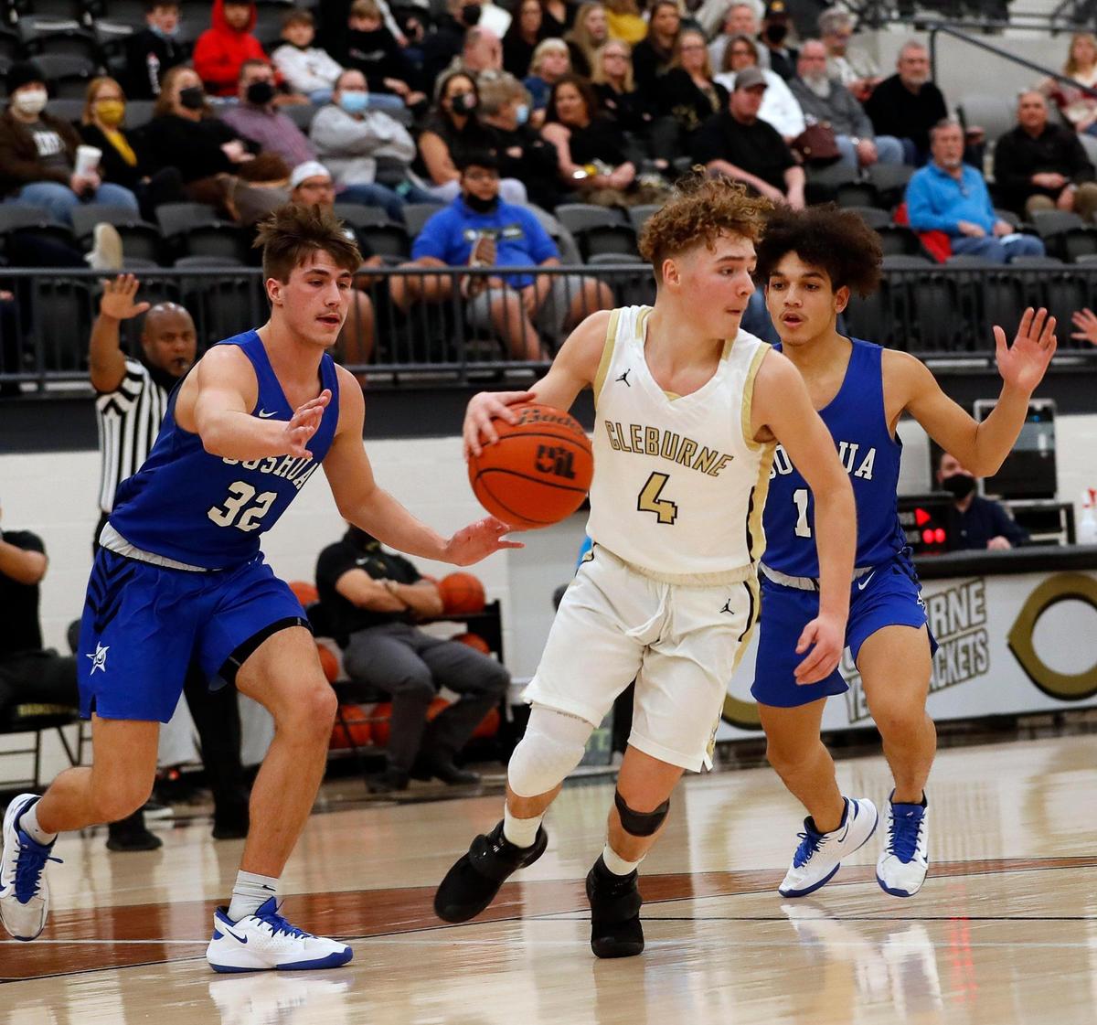 Cleburne’s Cole Mullens (4) drives against the defense of Joshua guard Nathaniel Fernandez (10) and center Noah Smith (32) during the first half of a 14-5A high school basketball game at Cleburne High School in Cleburne, Texas, Tuesday, Feb. 09, 2021. Joshua led 43-28 at the half. (Special to the Star-Telegram Bob Booth)