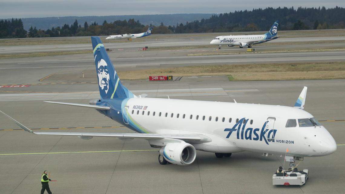 A passenger plane with Horizon Air, a regional airline based in SeaTac, Washington, that is a sister carrier with Alaska Airlines, is pushed out for taxi, Monday, Oct. 7, 2019, at Seattle-Tacoma International Airport in Seattle. (AP Photo/Ted S. Warren)