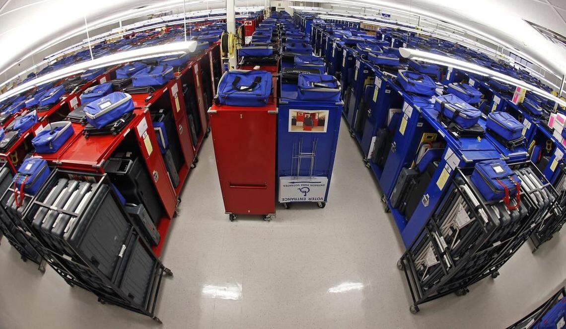 Hundreds of EEC (Election Equipment Carrier) voting machines, colored red and blue are prepared locally for polling places.