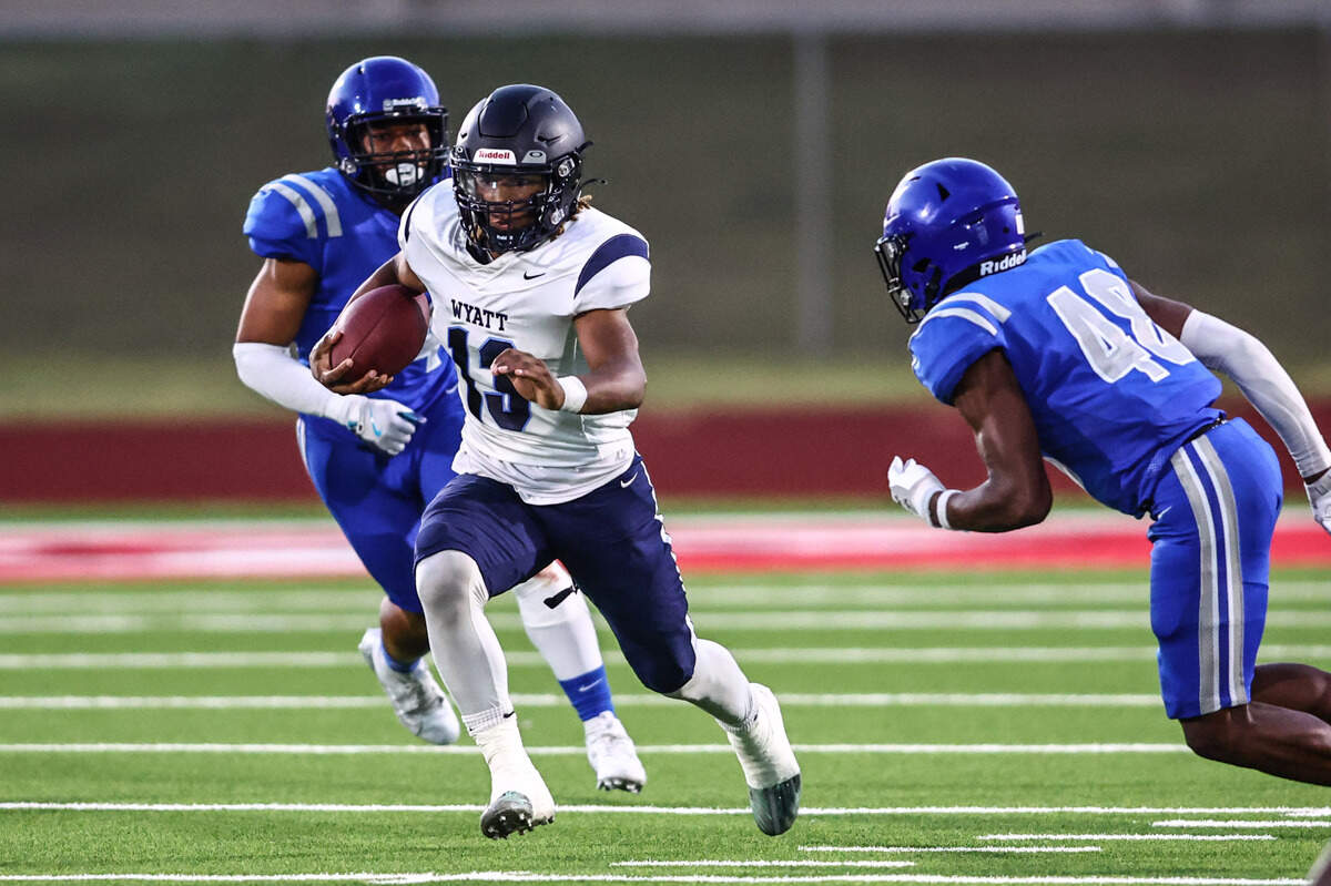 Wyatt quarterback Jorvorskie Lane, Jr. is chased down by Dunbar linebacker Jaclyn Johnson (48) on Thursday, September 5, 2024 at Clark Stadium in Fort Worth, Texas. Dunbar rallied to defeat Wyatt 14-13.