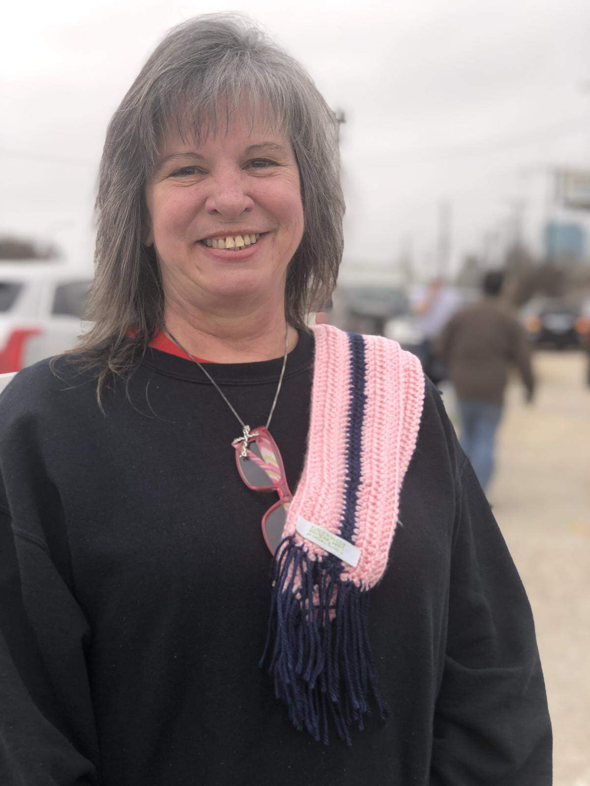 Cheryl Burrow, a special education teacher in Lake Dallas ISD, wear one of the one hundred scarves she crocheted for donation. Each scarf has a label that honors her late son who died in a car accident in 2012.