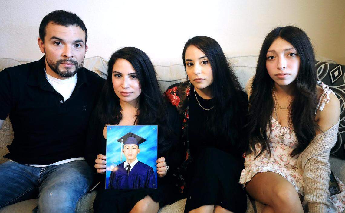 Sarah Magana holds a photograph of her son, Josh Balcazar, with her husband Julian and daughter Savannah, right, and Josh’s aunt, Katie Gonzalez.