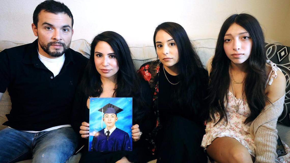Sarah Magana holds a photograph of her son, Josh Balcazar, with her husband Julian and daughter Savannah, right, and Josh’s aunt, Katie Gonzalez.