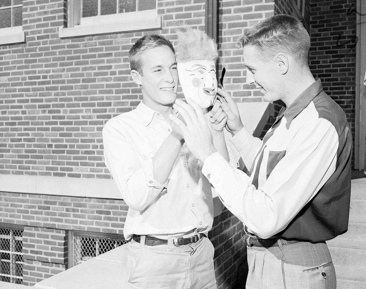 Oct. 28, 1952: “If North Side’s Jack Webb, right, looks behind the Halloween mask he will find Edward (Buzz) Kemble, ace of the Arlington Heights backfield. Webb, 195 pounds ramrod of the Steers’ attack, and speedster Kemble will match heroics Friday night in the first ‘big game’ of the city high school football race.”