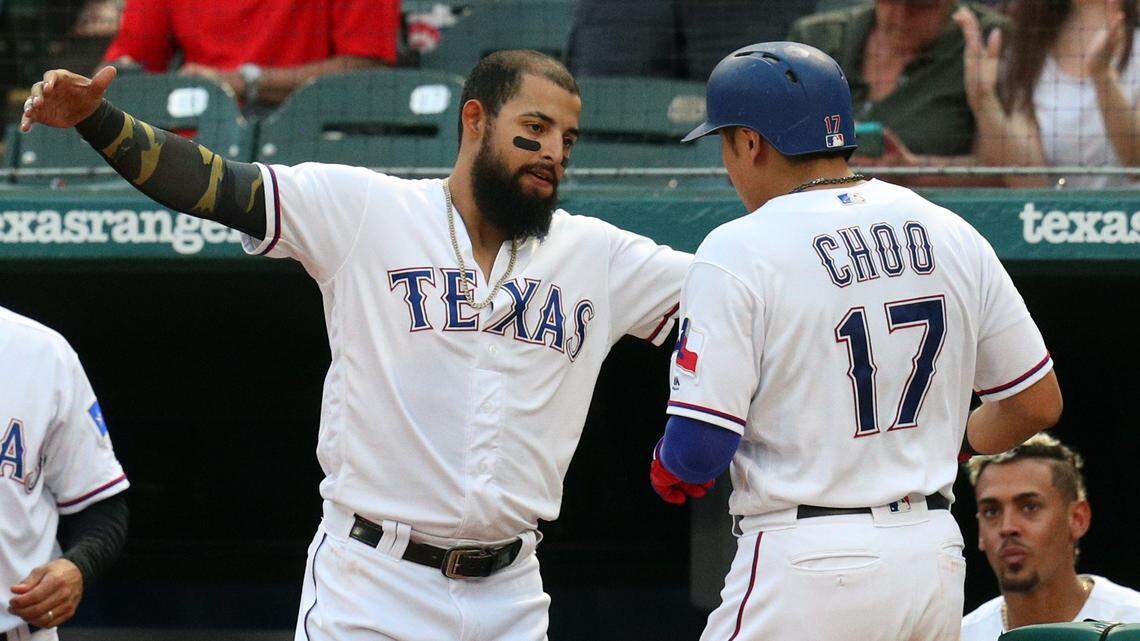Shin-Soo Choo gets a bear hug Friday after his two-run homer from Rougned Odor, who hit a three-run homer only a few batters earlier in the Rangers’ 7-3 win.