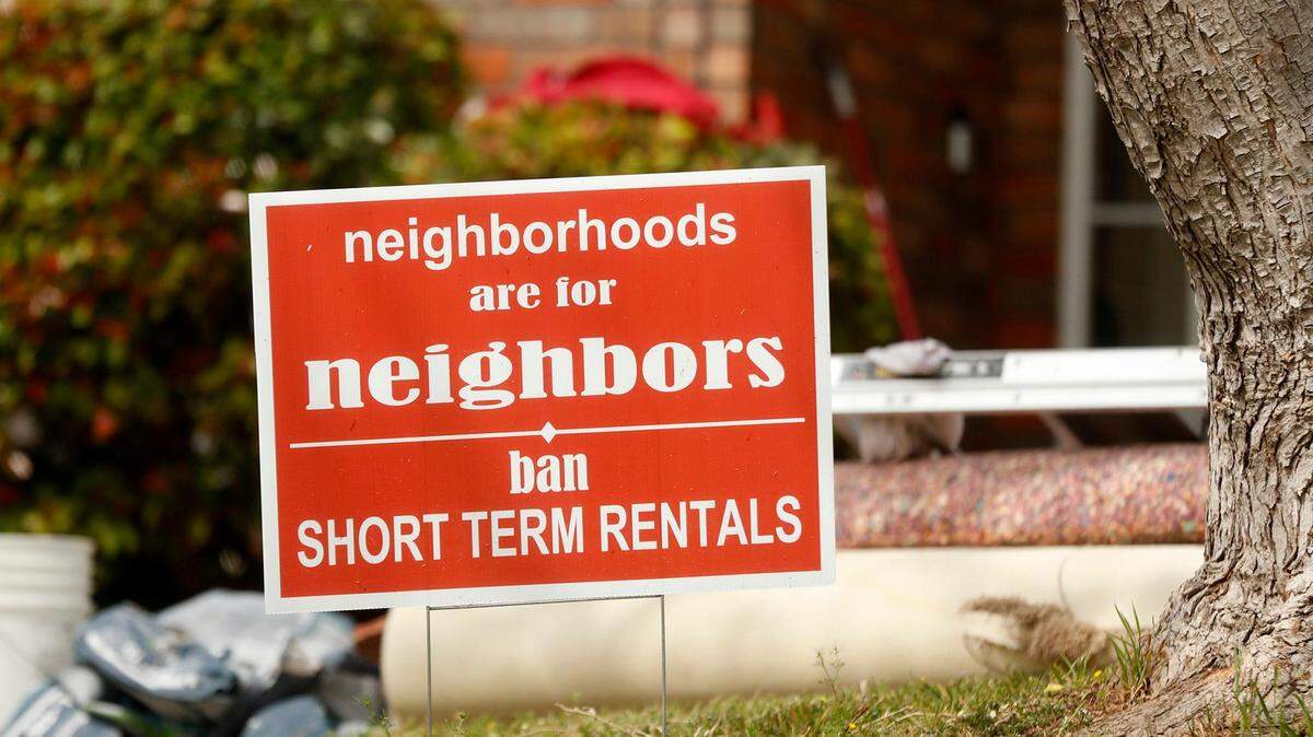 A sign opposing short-term rentals is posted in the front yard of a Tarrant County home in this file photo.