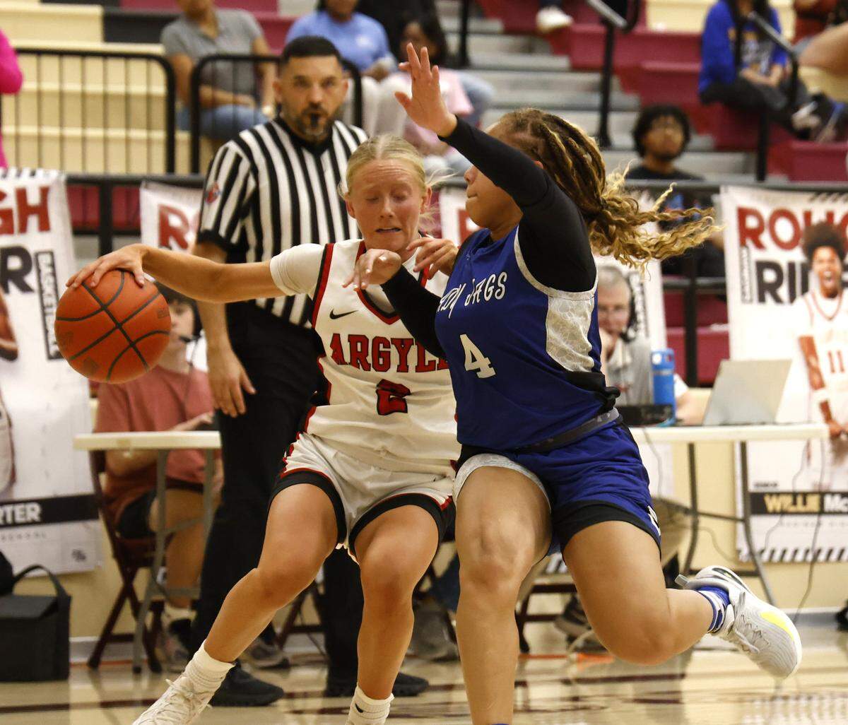 Argyle guard Kensley Vest (2) works against Mansfield Summit guard I'yunna Warner (4) in the corner during the second half of a UIL Class 5A DII girls playoff basketball game at Saginaw High School in Saginaw, Texas, Thursday Feb. 19, 2026.