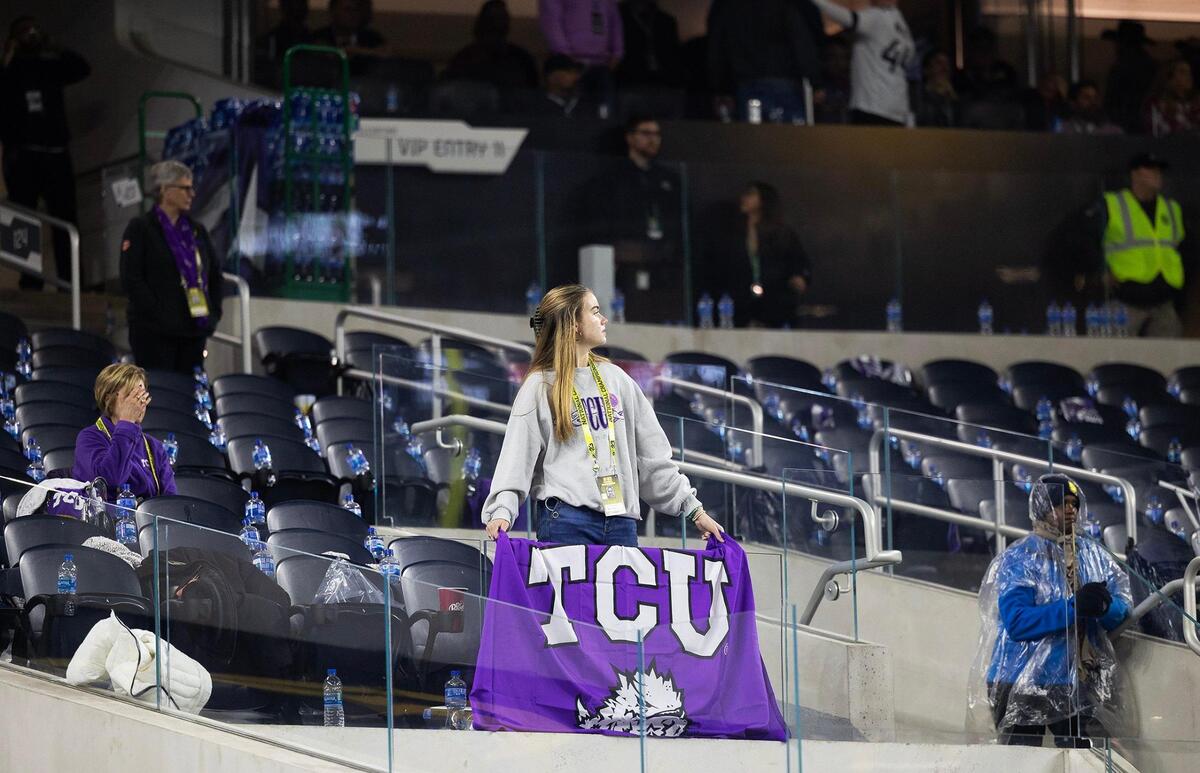 A fan holds up a TCU flag in the stands before the end of the second quarter at the 2023 College Football Playoff National Championship on Monday, January 9, 2023, at SoFi Stadium in Inglewood, Calif.