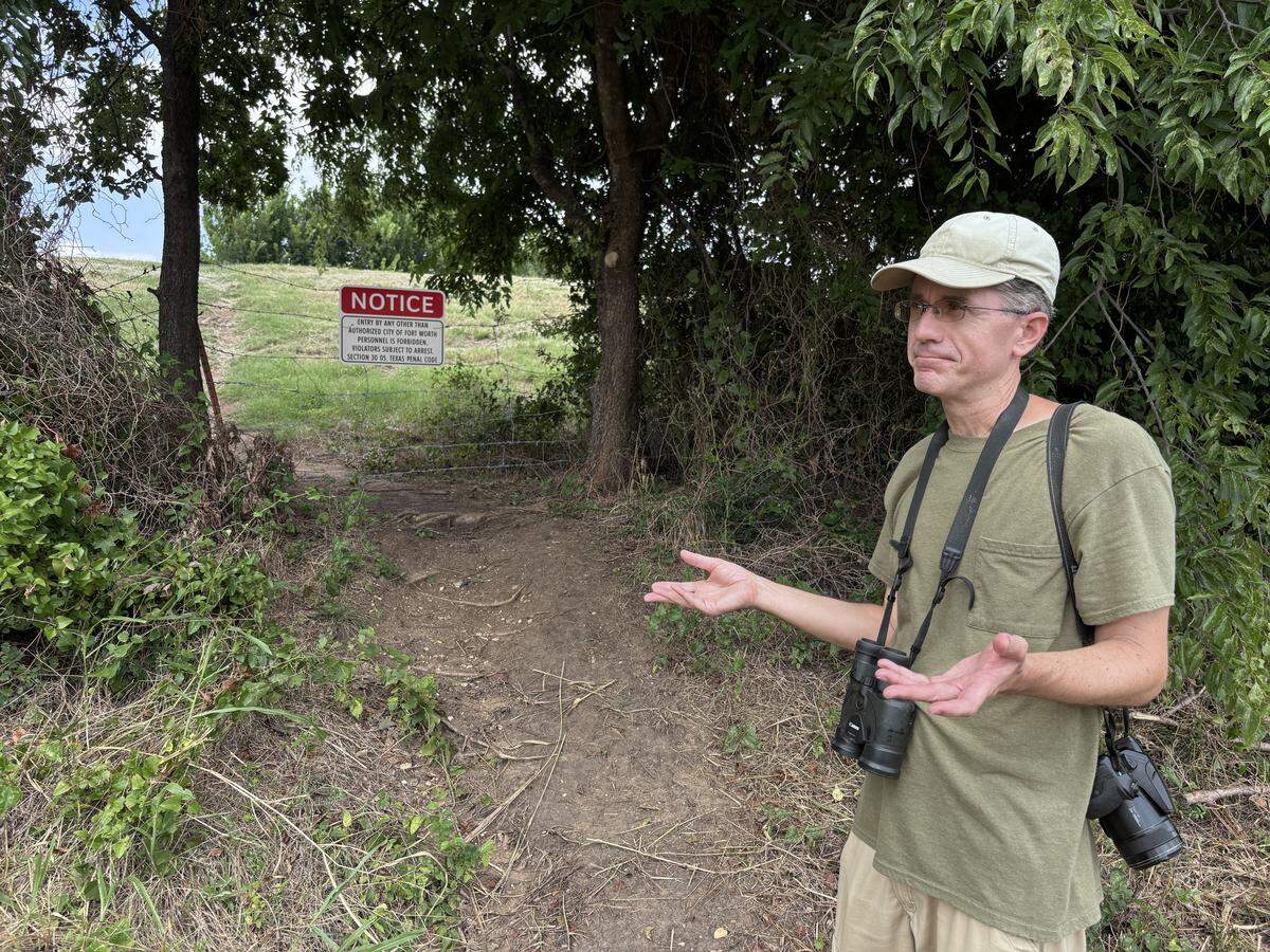 Colby Ayers, of Euless, speaks about the access he and other birdwatchers had to the Village Creek Drying Beds before the city of Fort Worth closed them off due to cleanup from an oil spill in May 2025. He and other birders used to access the sight through a breach in the fence behind him, or through the main gate, with permission from the city.
