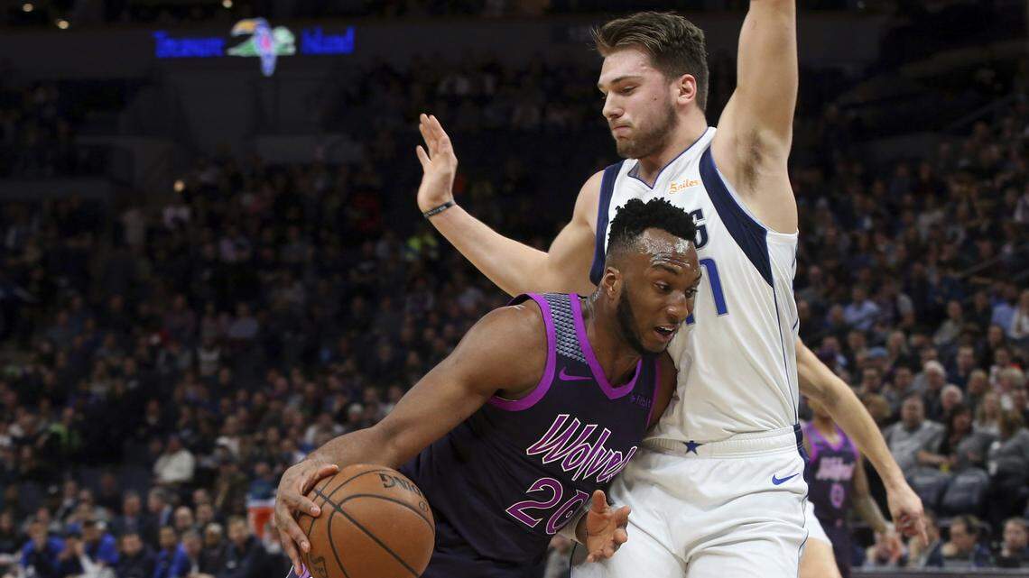 Minnesota Timberwolves’ Josh Okogie, left, of Nigeria, drives into Dallas Mavericks’ Luka Doncic, of Slovenia, in the first half of an NBA basketball game Friday, Jan. 11, 2019, in Minneapolis. (AP Photo/Jim Mone)