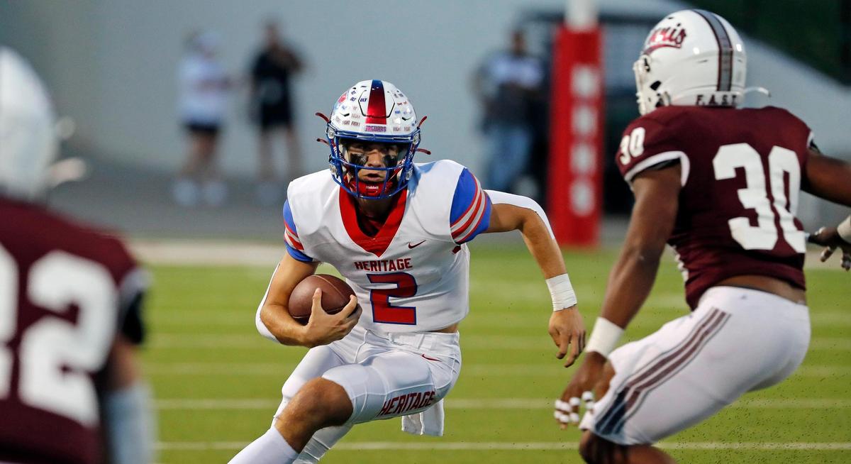 Heritage quarterback Kaden Brown (2) scrambles out of the backfield in the first half of a District 5-5A Division II high school football game at Midlothian ISD Multi-use Stadium in Midlothian, Texas, Friday, Oct. 14, 2022. Midlothian led Ennis 20-7 at the half. (Special to the Star-Telegram Bob Booth)