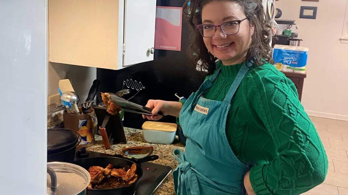 Fort Worth teacher Kathleen Cluchey prepares a meal for her family of seven in her home kitchen.
