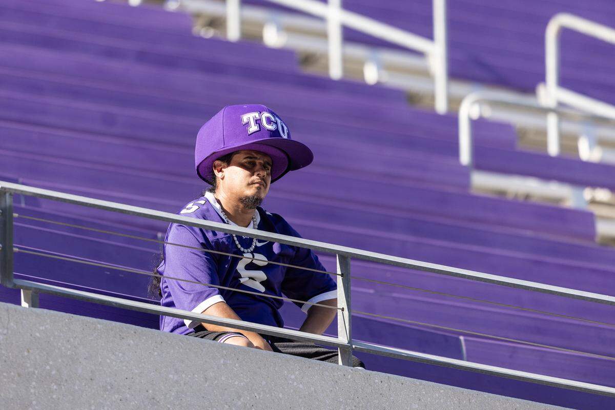 A fan sits alone in the stands after three rain delays before resuming action in the second half of a Big XII football game between the TCU Horned Frogs and the Baylor Bears at Amon G Carter Stadium in Fort Worth on Saturday, Oct. 18, 2025.