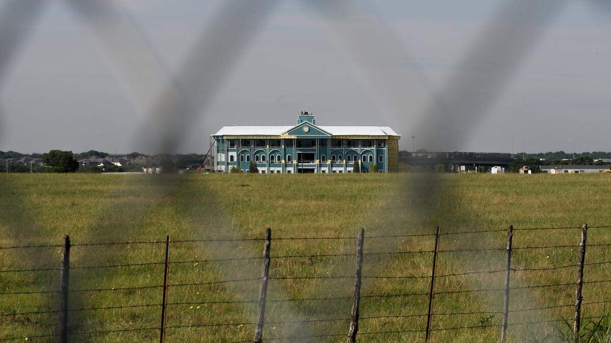 The new Mansfield City Hall stands behind a fence while under construction in north Mansfield on June 3, 2026. Mansfield plans to move into the new city hall in early 2027. 