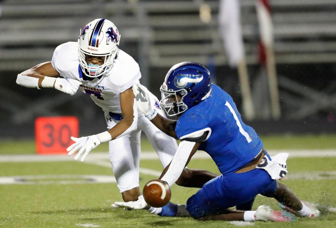 Midland Christian wide receiver Christopher Brazzell (7) and Nolan Catholic defensive back Keontae Williams (1) battle for the ball during a high school football game at Doskocil Stadium in Fort Worth, Texas, Friday, Oct. 02, 2020. Nolan Catholic defeated Midland Christian 38-21. (Special to the Star-Telegram Bob Booth)