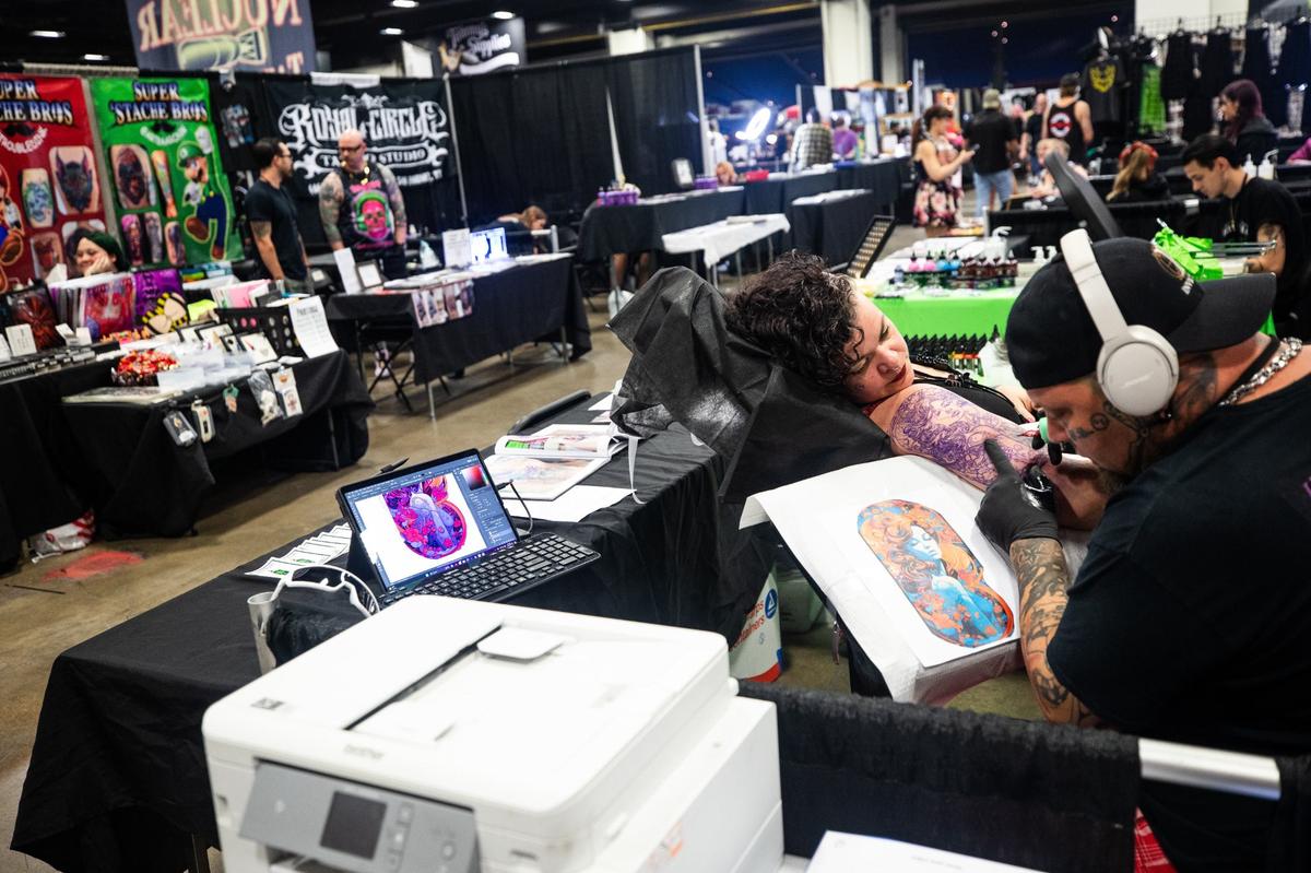 Tattoo artists work on designs for clients at booths set up around the event during Fort Worth Tattoo Arts Festival on Friday, June 7, 2024, at the Fort Worth Convention Center. Various artists from around the states come and work with clients and show off their skills.