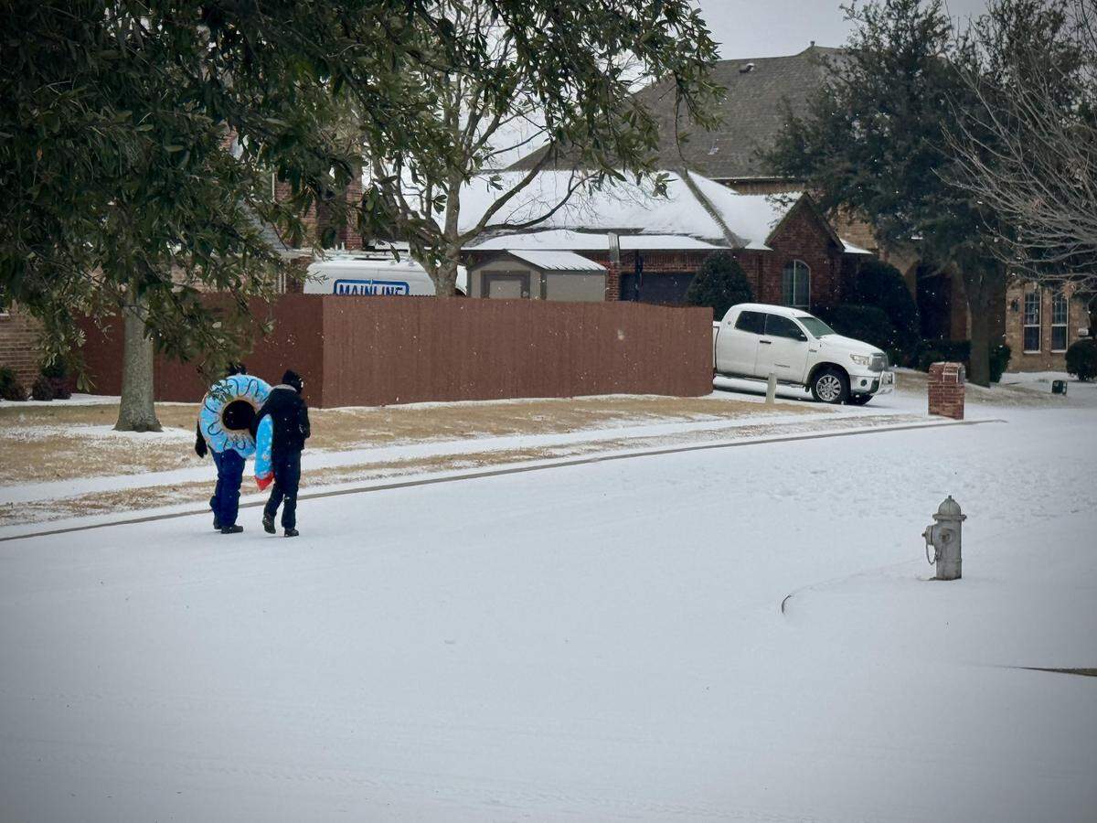 Two boys carry pool floats to go sledding in a far north Fort Worth neighborhood on Sunday, Jan. 25, 2026.