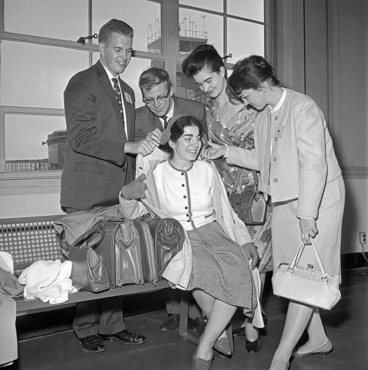 Anahid Alexanian of Canada, seated, is helped out of her car muffs by Marlene Linzmeyer, right, while Manigirdas Motekaitis, left, Ralph Votapek, and Elaine Keillor watch.