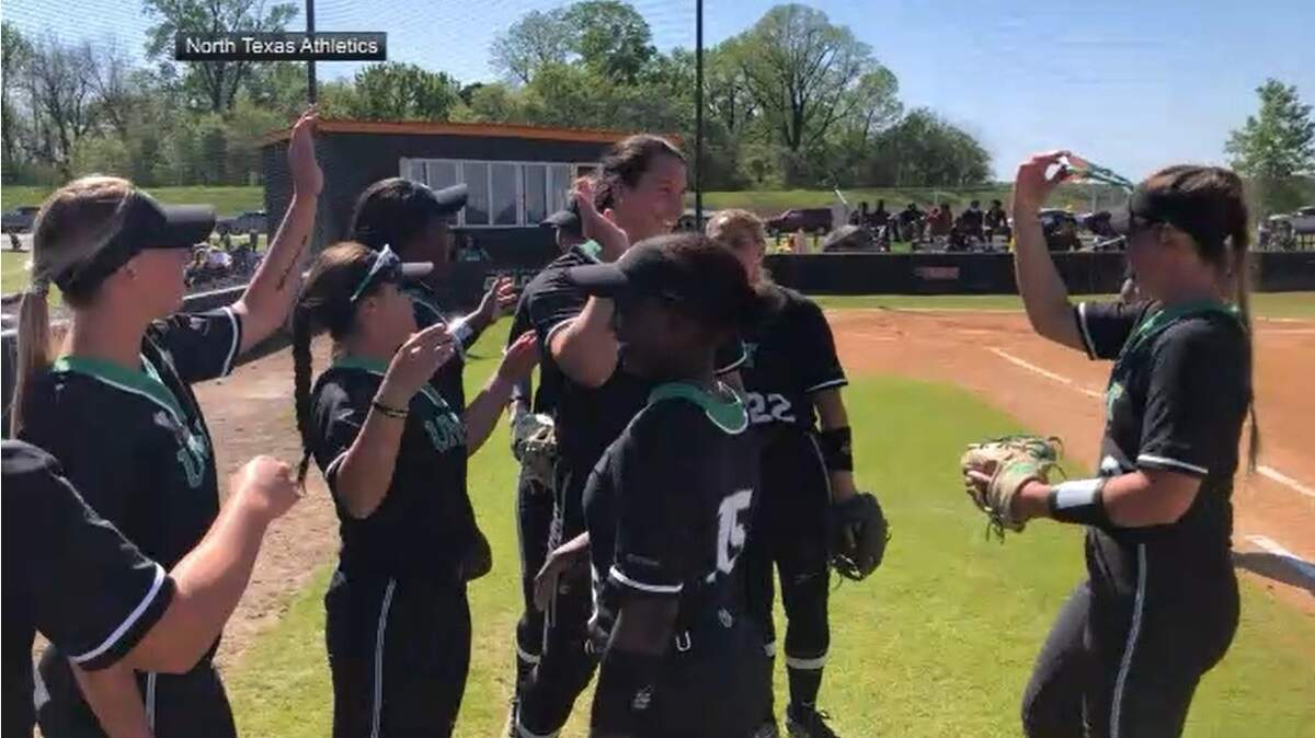 Right-handed pitcher Hope Trautwein, who made North Texas history on Sunday, high-fives her teammates after the final out.