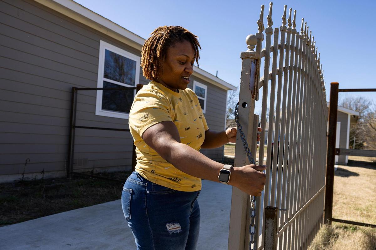 Smith showing off the driveway gate that she and her step-father pieced together.