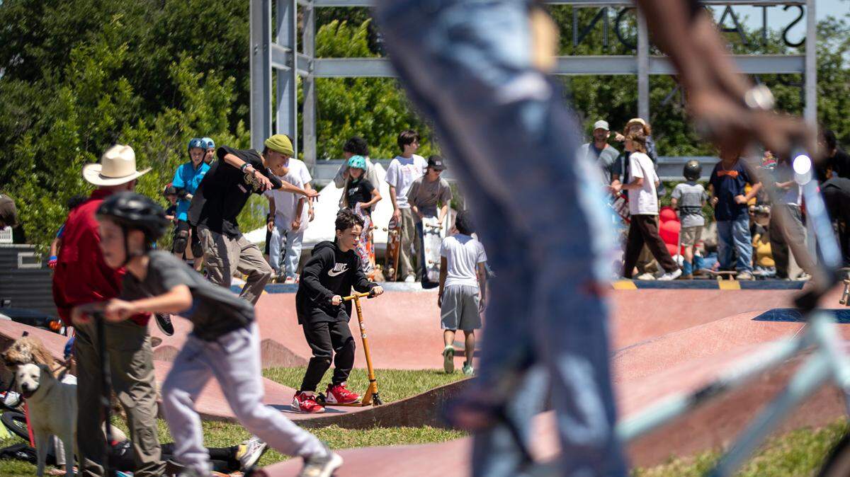 Carson Zayne Timmons, 10, from Fort Worth, shreds on his orange scooter at the Dickies Skate Plaza in Fire Station Park on Saturday in Fort Worth. The opening day event featured live music, food trucks and local vendors like Magnolia Skate Shop.