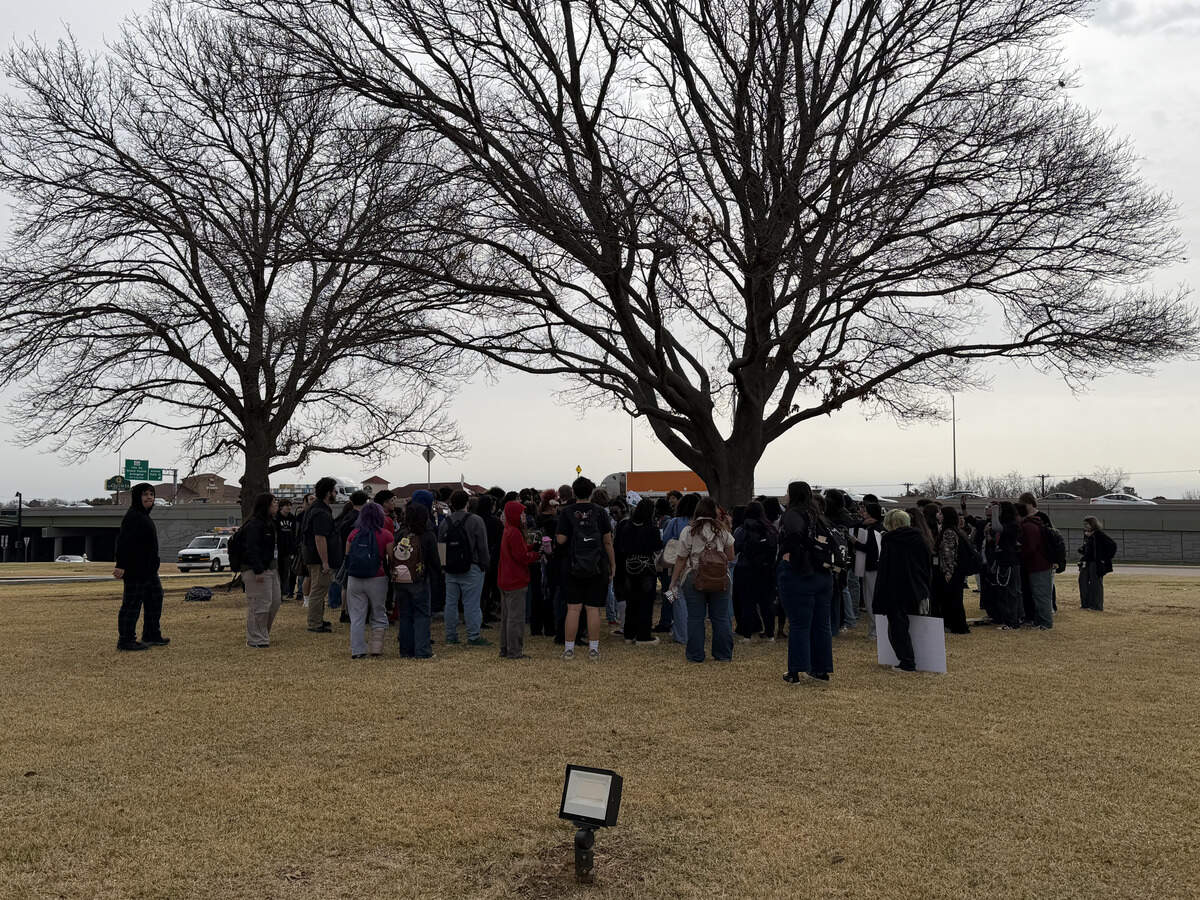 Students gathered in a circle to discuss what to chant during their anti-ICE walkout at Euless City Hall.