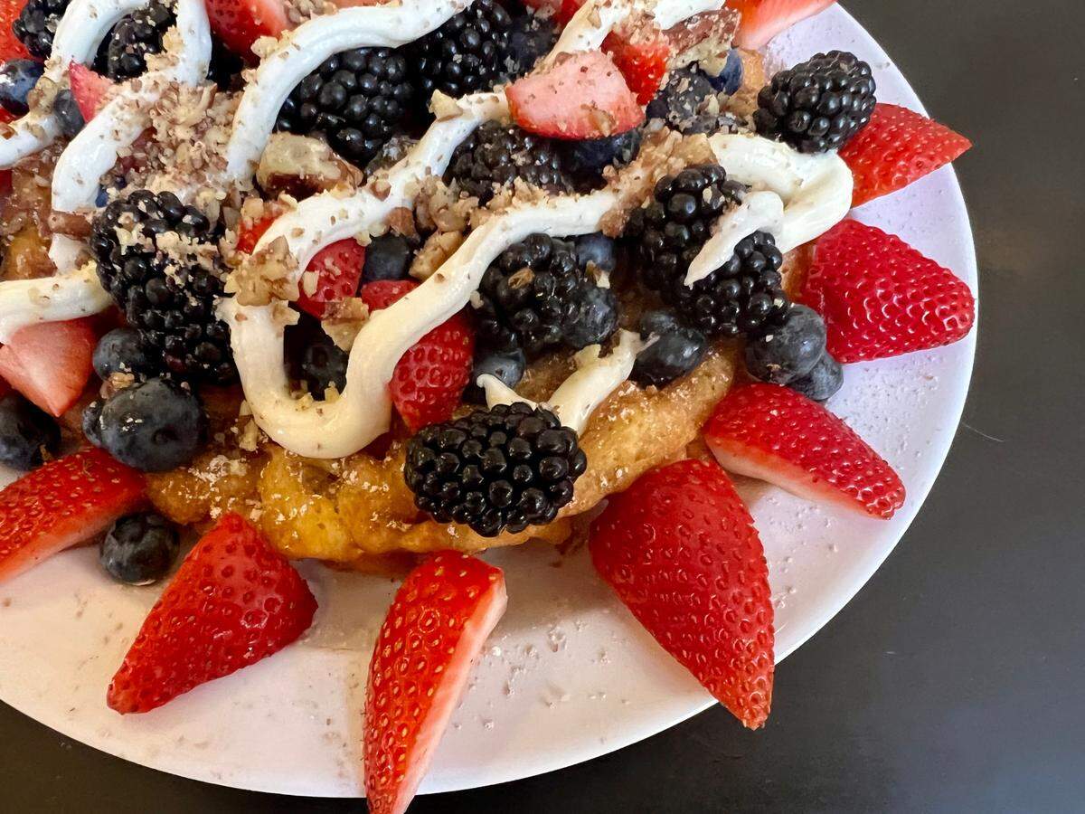Funnel cake with berries, granola and lemon cream is on the Sunday brunch menu at T & P Tavern, inside the historic downtown Fort Worth railway station now serving the Trinity Railway Express.
