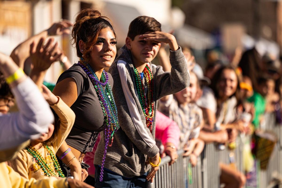 Spectators watch as the parade floats roll by them during the big parade for the 15th Annual Mardi Gras Nocona Style on Clay Street in Nocona on Saturday, Mar. 1, 2025.