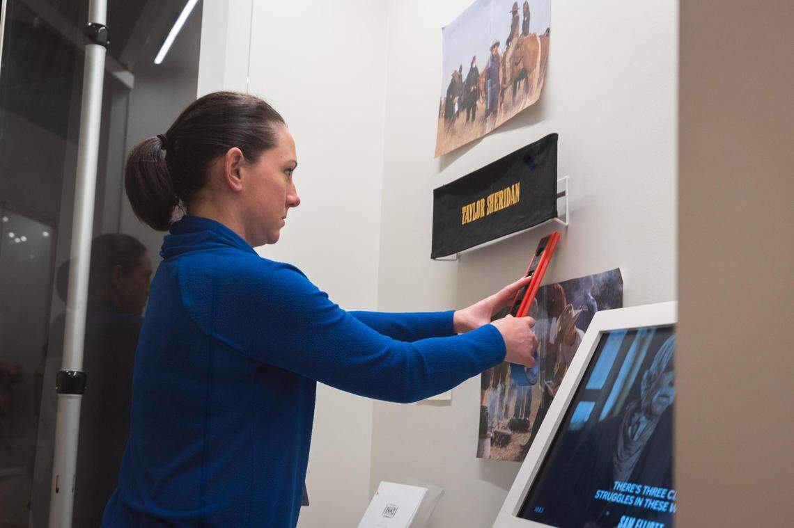 Ashley Kowalski hangs photos for the 1883 exhibit Tuesday, Feb. 8, 2022, at the National Cowgirl Museum & Hall of Fame in Fort Worth. The exhibit opens Friday, Feb. 11.