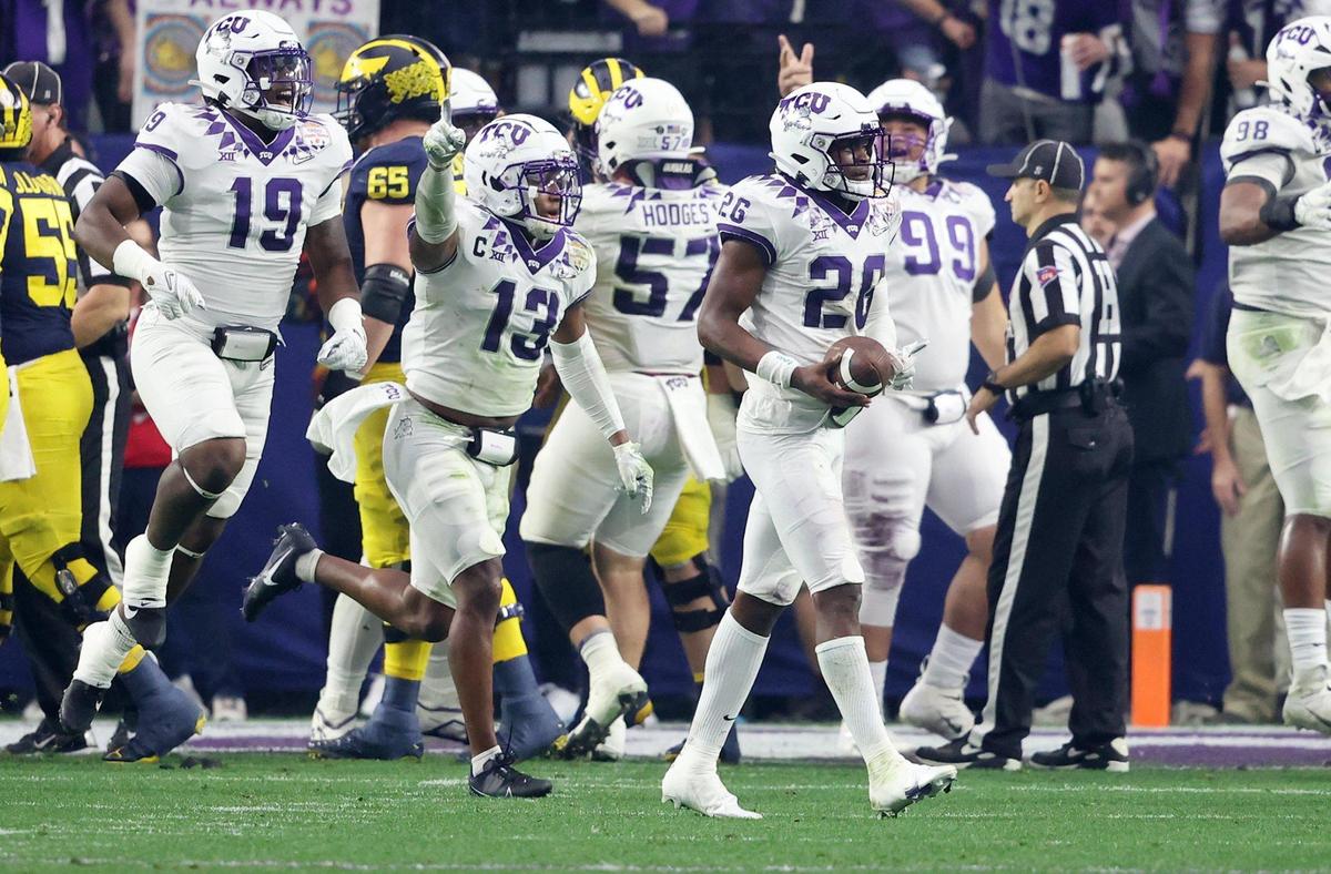 TCU reacts after picking up a turnover at the Michigan end zone during the Vrbo Fiesta Bowl at State Farm Stadium in Glendale, Ariz., on Saturday, December 31, 2022.