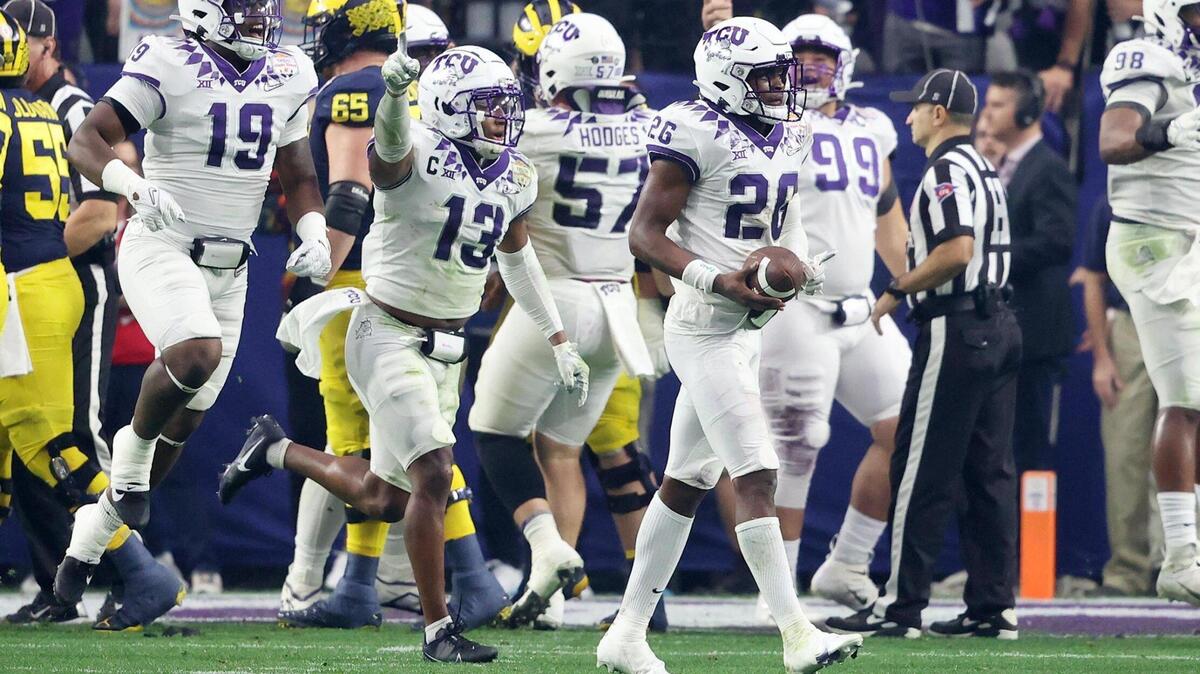 TCU reacts after picking up a turnover at the Michigan end zone during the Vrbo Fiesta Bowl at State Farm Stadium in Glendale, Ariz., on Saturday.