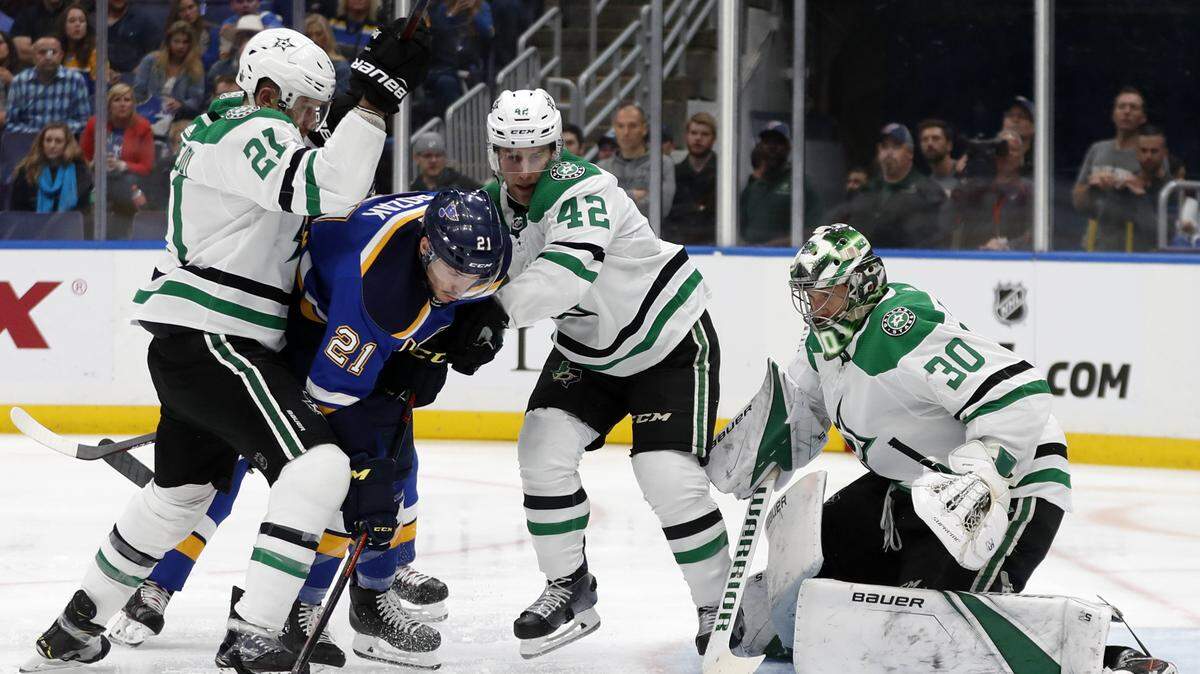 Dallas Stars’ Ben Lovejoy, left, and defenseman Taylor Fedun help goalie Ben Bishop defend against pressure from St. Louis Blues center Tyler Bozak during Game 1 of the second round playoff series Thursday night at Enterprise Center in St. Louis, Mo.