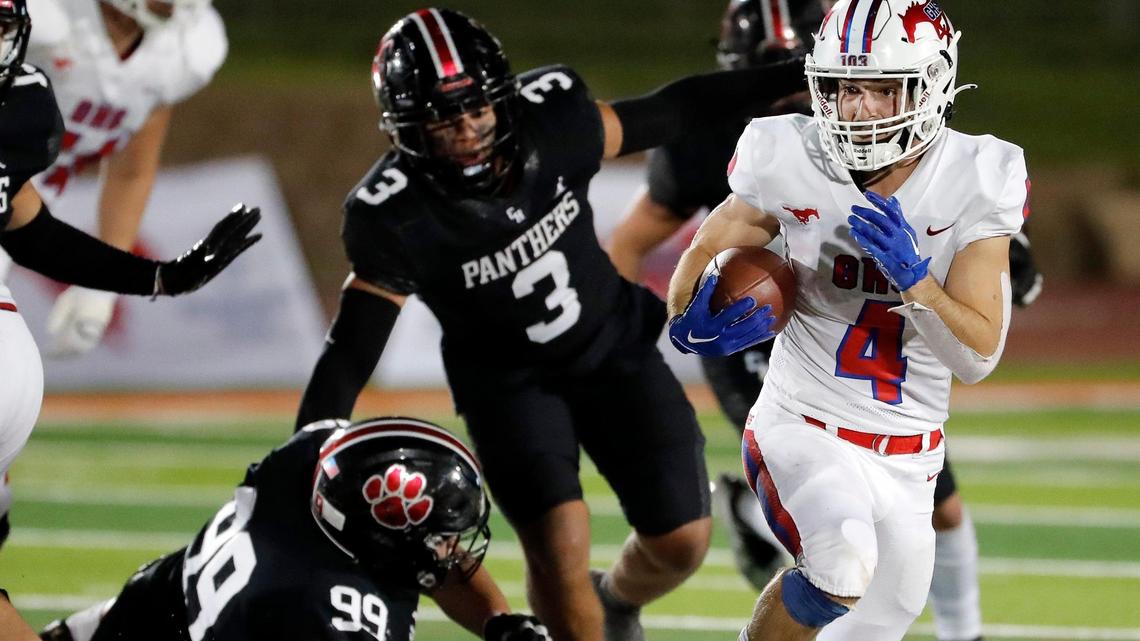 Grapevine running back Parker Polk (4) breaks out of the backfield chased by Heritage defensive lineman Keyvaughn Connor (3) in the second half of a high school football game at Mustang-Panther Stadium in Grapevine Texas, Friday, Sept. 30, 2022. Grapevine defeated Colleyville Heritage 44-26 for The Battle of the Red Rail. (Special to the Star-Telegram Bob Booth)
