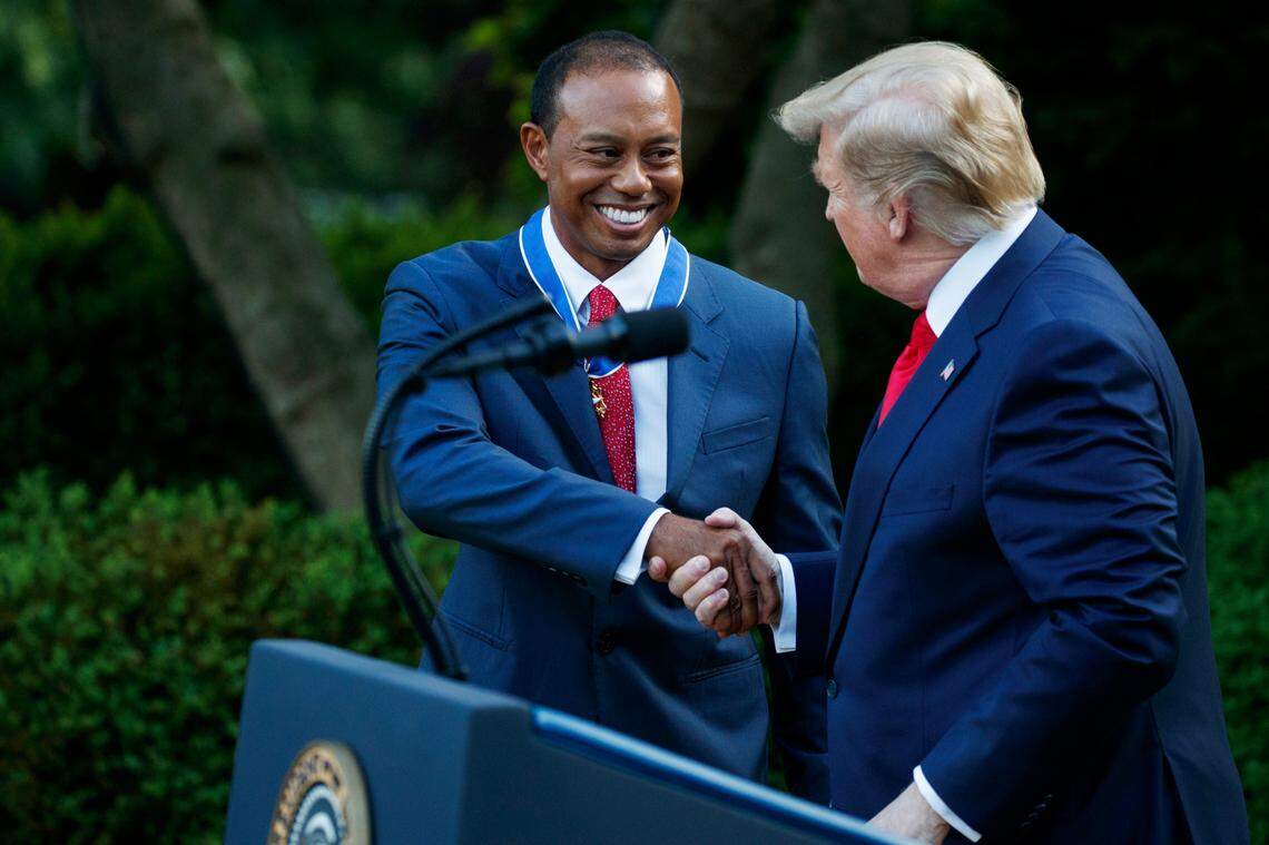 FILE - In this Monday, May 6, 2019, file photo, President Donald Trump shakes hands with golfer Tiger Woods after awarding him Presidential Medal of Freedom, in the Rose Garden of the White House, in Washington. The visit was Woods’ only public appearance until he goes to Bethpage Black for the PGA Championship, on May 16. (AP Photo/Evan Vucci, File)