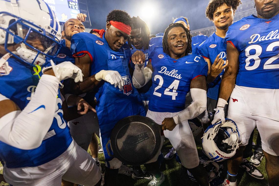 The SMU football team celebrate with the Iron Skillet after defeating TCU 66-42 in the Iron Skillet rivalry game at Gerald J. Ford Stadium in Dallas on Saturday, Sept. 21, 2024.