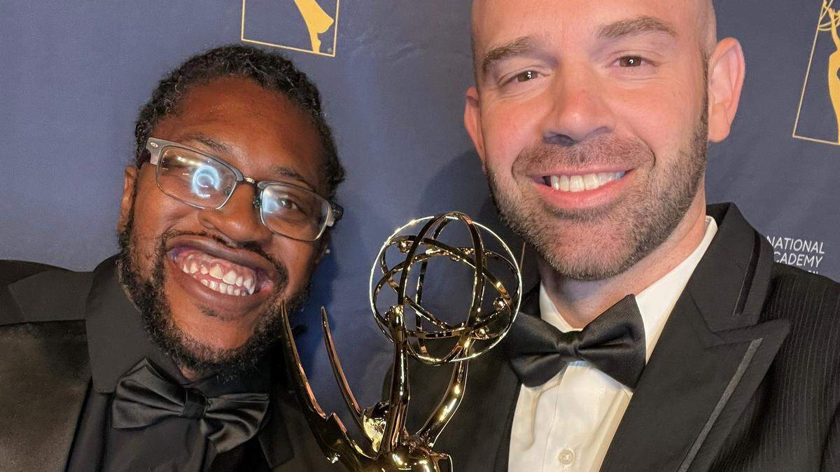 Christopher Irvin, great grandson of George Dawson, and journalism and social studies teacher Joshua Ault, right.