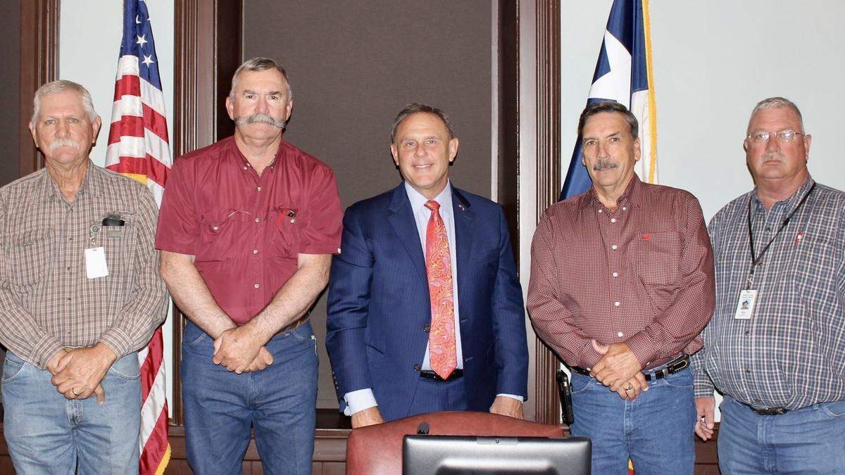 Judge Pat Deen, center, and the Parker County Commissioners’ Court believe the county is under foreign attack.