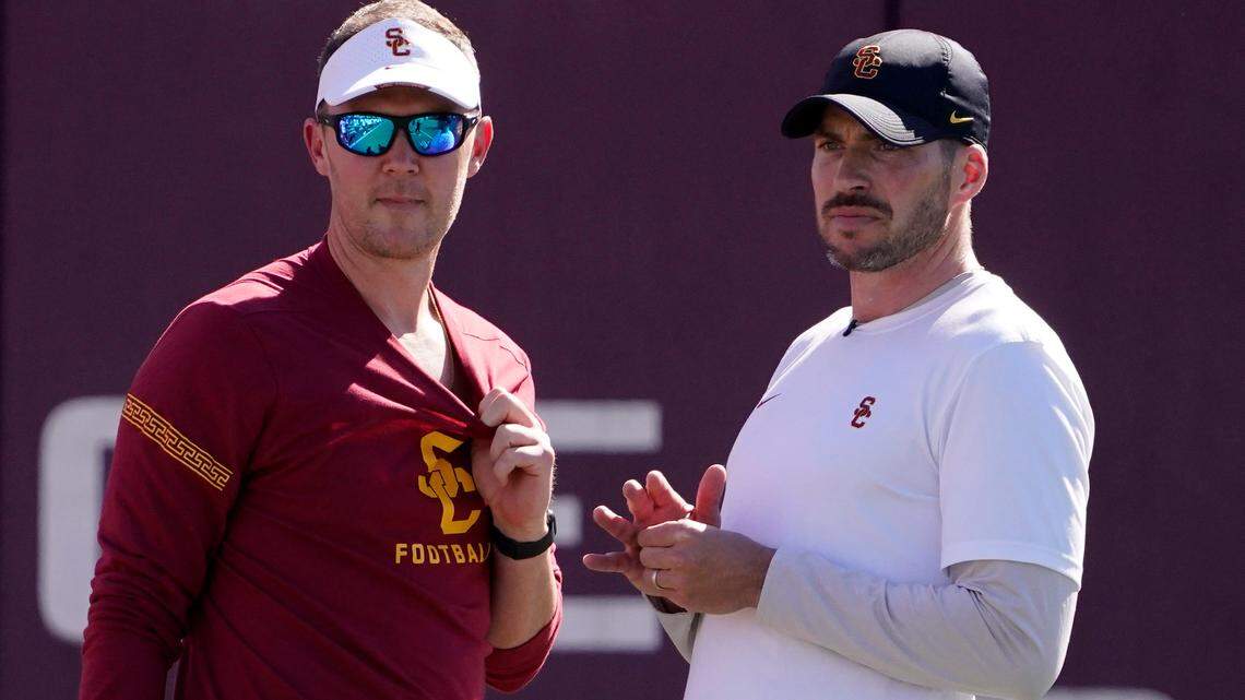 Southern California head coach Lincoln Riley, left, talks with defensive coordinator Alex Grinch during a football practice.