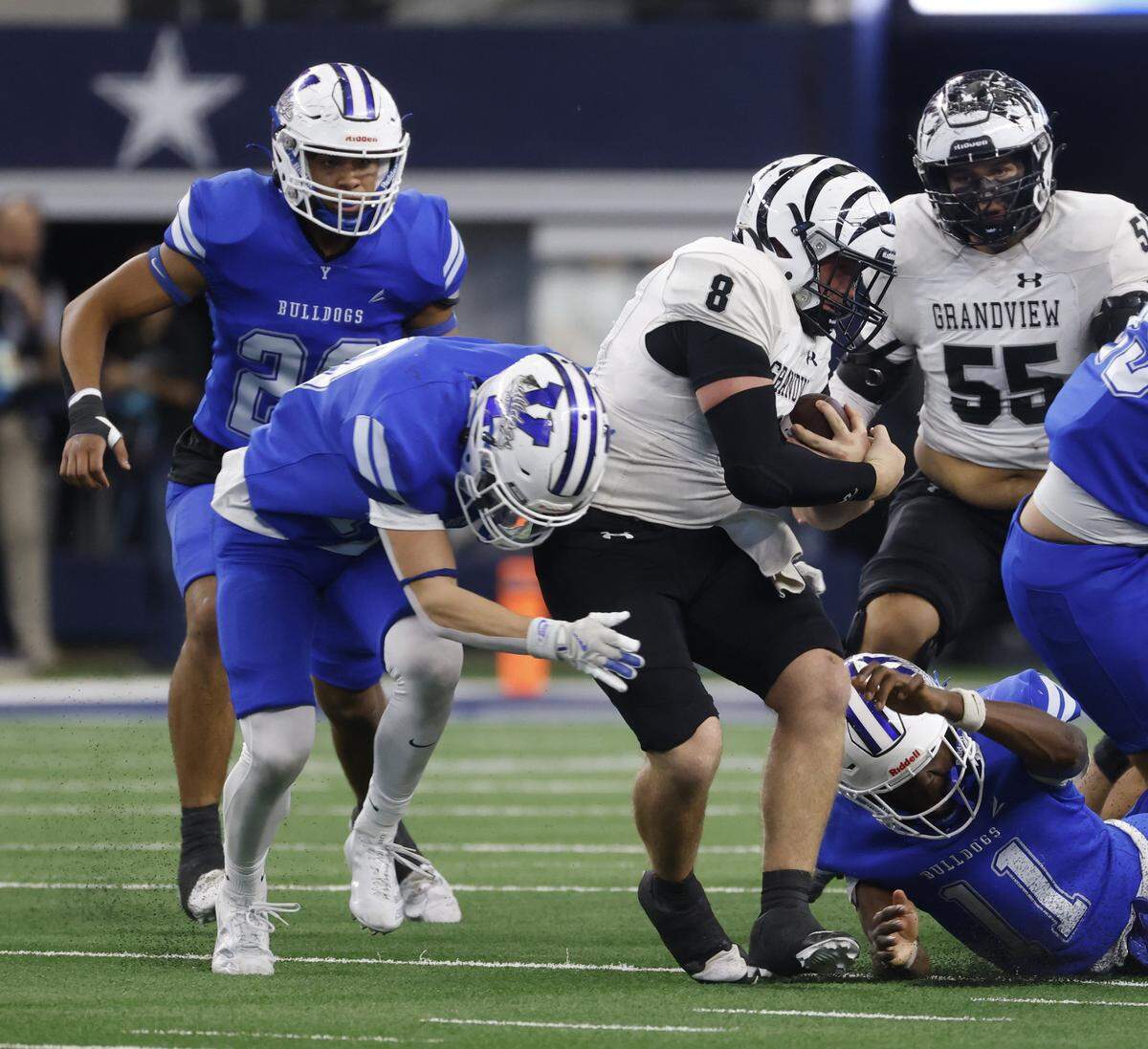 Grandview quarterback Mason Landers (8) breaks up the middle for a few yards against Yoakum linebacker X'Zavier Barnett (11) during the first half of a UIL Class 3A Division I championship game on Thursday Dec. 18, 2025 at AT&T Stadium in Arlington, Texas.