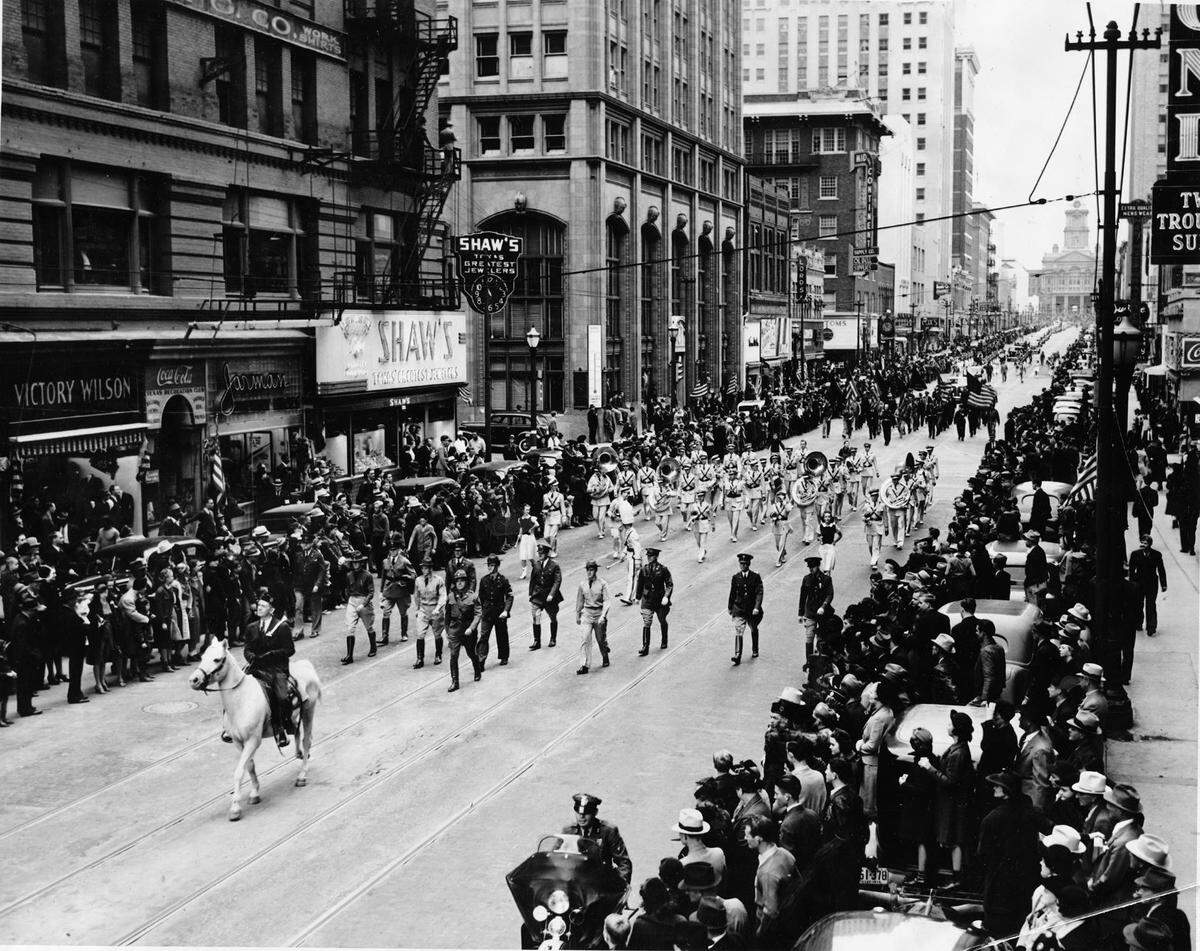 Armistice Day Parade in downtown Fort Worth on Nov. 11, 1938, marked 20 years after the end of World War I. The parade grand marshall, Haywood Davis, is followed by the Texas Christian University band with Main Street and the Tarrant County Courthouse in the background.