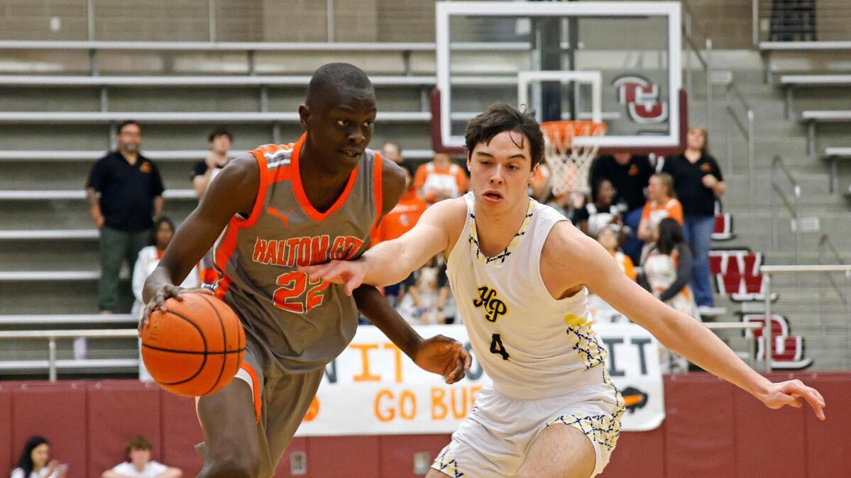 Haltom forward Kuol Atak (22) drives the ball around Highland Park guard Will Saunders (4) in the first period of a UIL Conference 6A Division 1 boys bi-district basketball playoff game at Lewisville High School in Lewisville, Texas, Tuesday, Feb. 20, 2024.