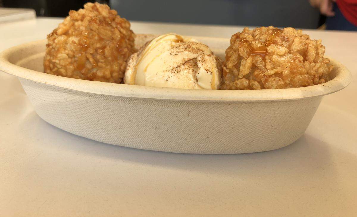 Sweet Crispy Rice/Arroz Con Leche is fried rice balls with a scoop of vanilla ice cream.