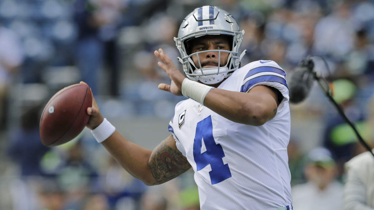 Dallas Cowboys quarterback Dak Prescott passes during warmups before an NFL football game against the Seattle Seahawks, Sunday, Sept. 23, 2018, in Seattle.