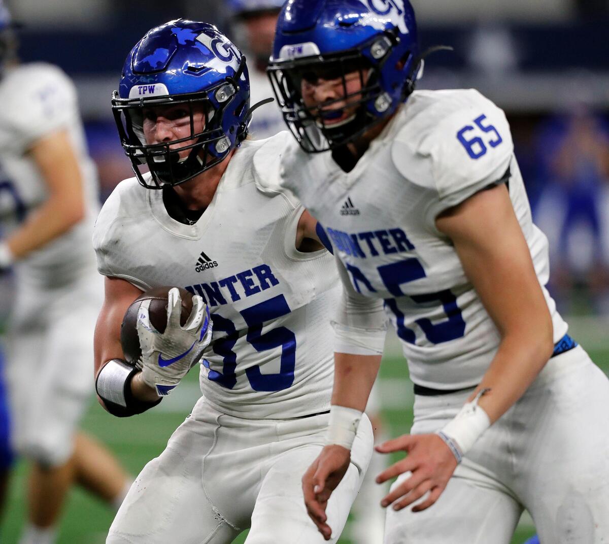 Gunter tail back Peyton Lowe (35) follows the blocking of lineman Trey Oblas (65) during the first half of a conference 3A division II State Championship football game at AT&T in Arlington, Texas, Thursday, Dec. 19, 2019. The game was tied at 22 at the half. (Special to the Star-Telegram Bob Booth)