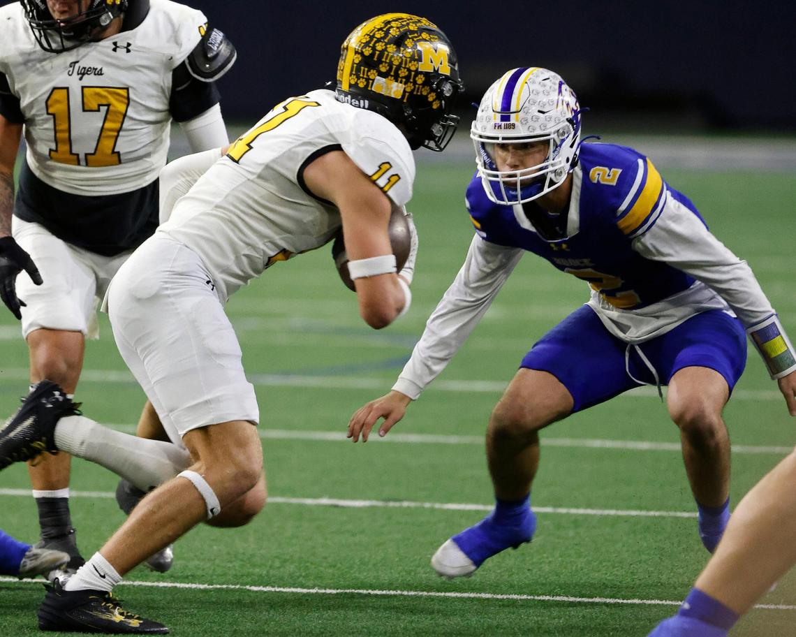 Brock quarterback Brody Woods (2) switched to defense as he zeros in on Malakoff linebacker Parker Poteete (11) after Poteete recovered a Brock fumble and returned it for six during the first half of a UIL Conference 3A Division 1 semifinal playoff football game at The Ford Center in Frisco, Texas, Thursday, Dec. 07, 2023.