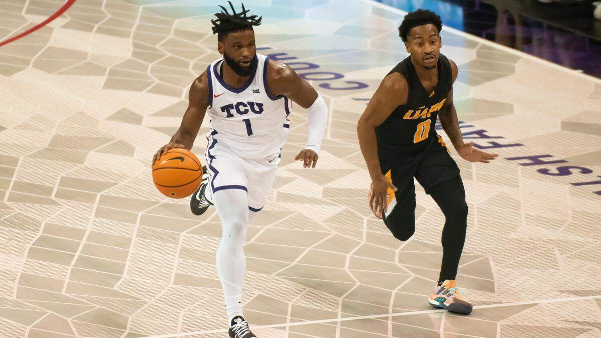 TCU guard Mike Miles Jr. (1) dribbles the ball down the floor past Arkansas-Pine Bluff guard Trejon Ware (0) in the first half of Monday’s game in Fort Worth.