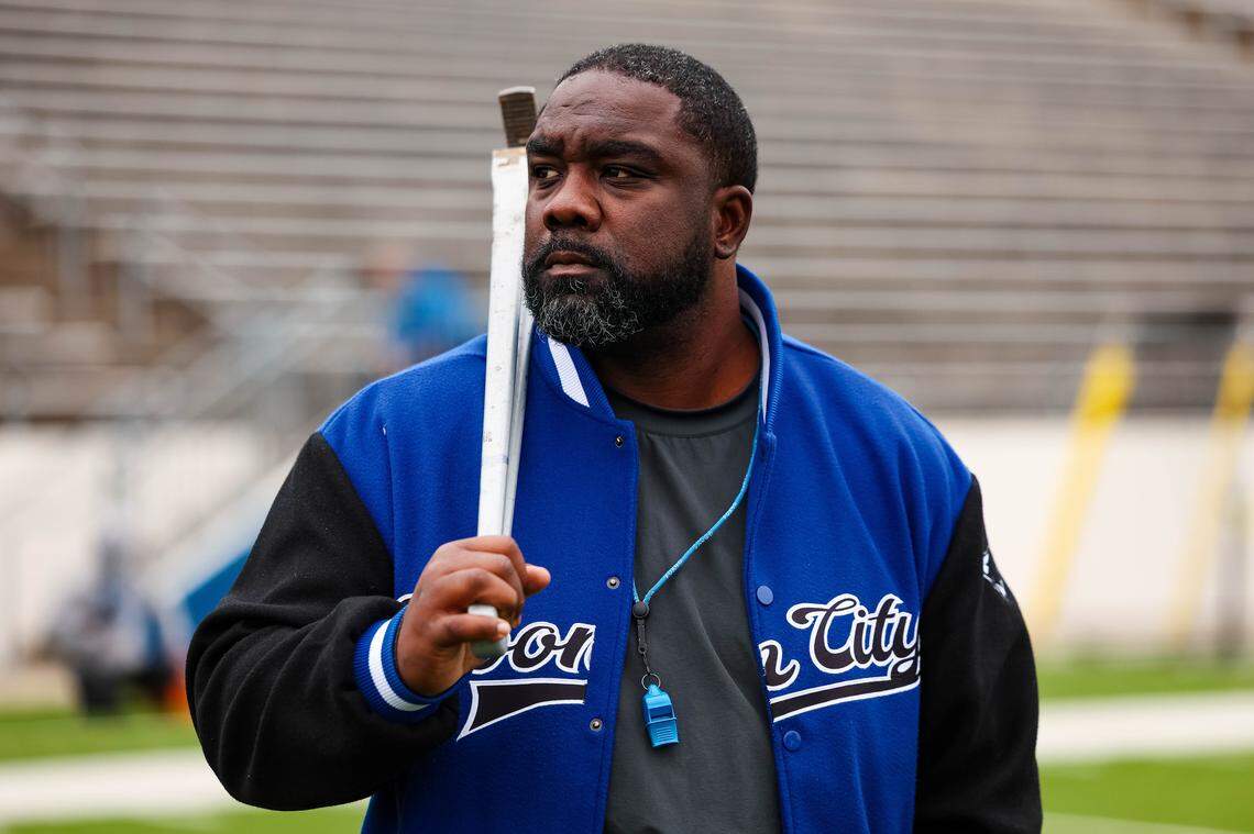 North Crowley head coach Ray Gates holds a wrench while staring toward his team during pregame warmups Saturday.