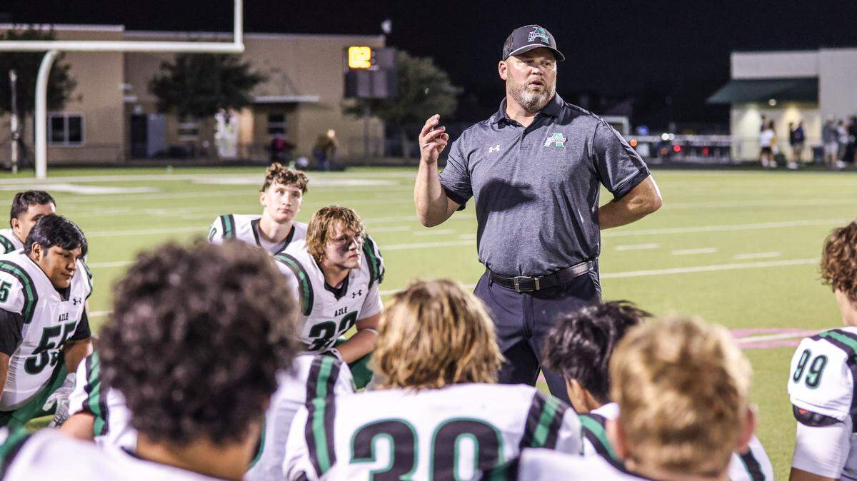 Azle coach Devon Dorris talks to his team after a 54-43 victory over Fossil Ridge last season at Keller ISD Stadium.