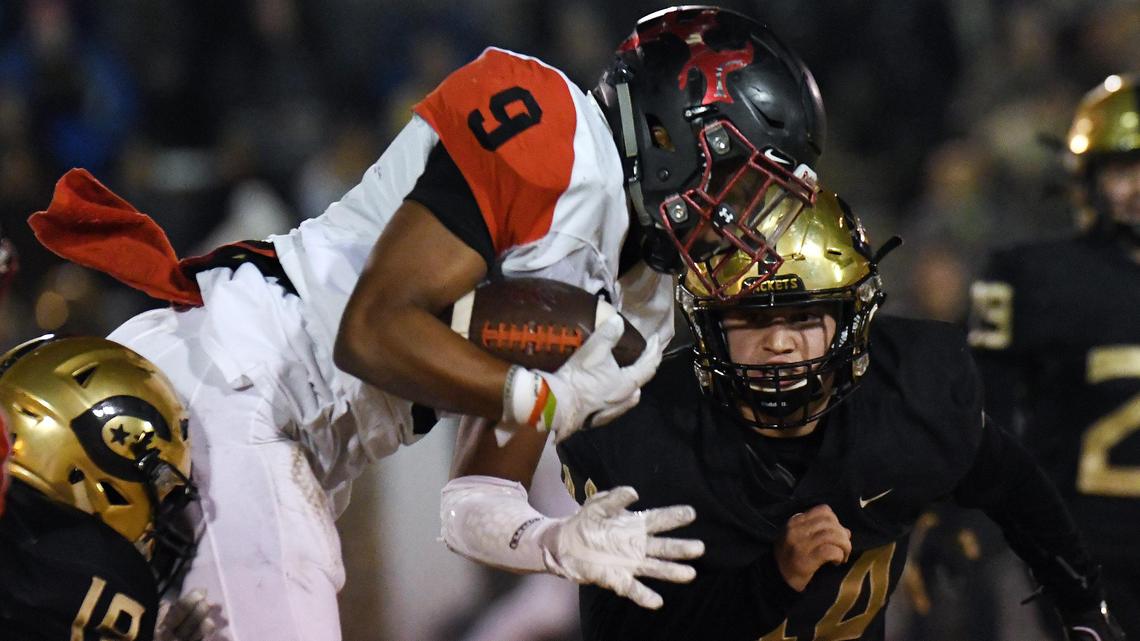 Burleson’s Caleb Lewis,center, is taken off his feet by Cleburne’s Juan Romero, left and Jaxon Bigham as he rushes for a first down in the first quarter during Friday’s November 8, 2019 football game at Yellow Jacket Stadium in Cleburne, Texas.